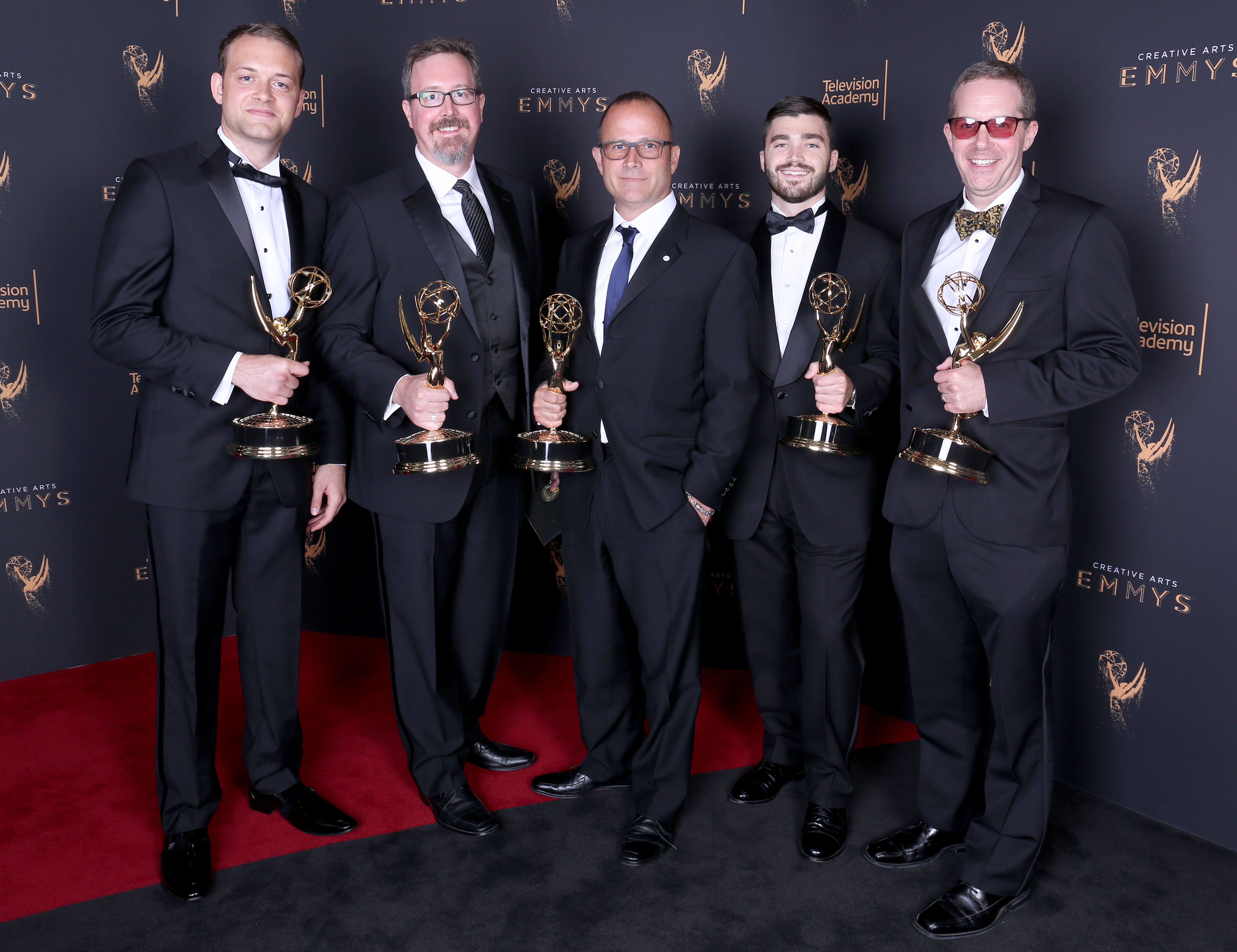 The sound editing crew for the Beatles documentary with their Emmys